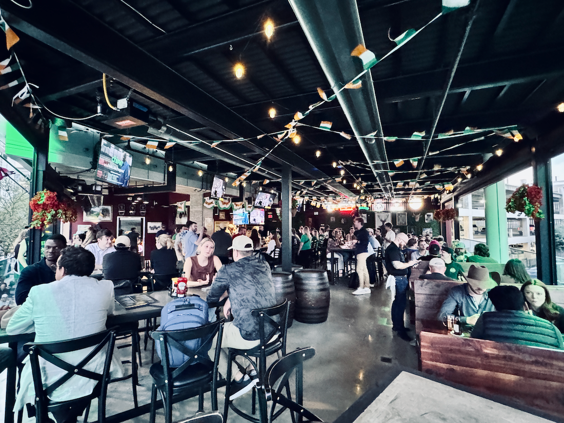 The Crafty Irishman's upstairs open-air bar full of people on a busy night.