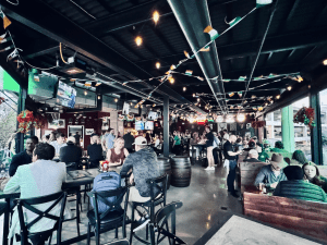 The Crafty Irishman's upstairs open-air bar full of people on a busy night.
