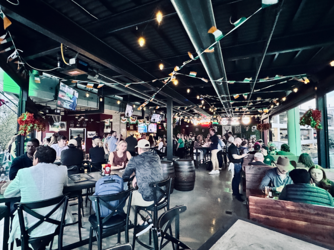 The Crafty Irishman's upstairs open-air bar full of people on a busy night.