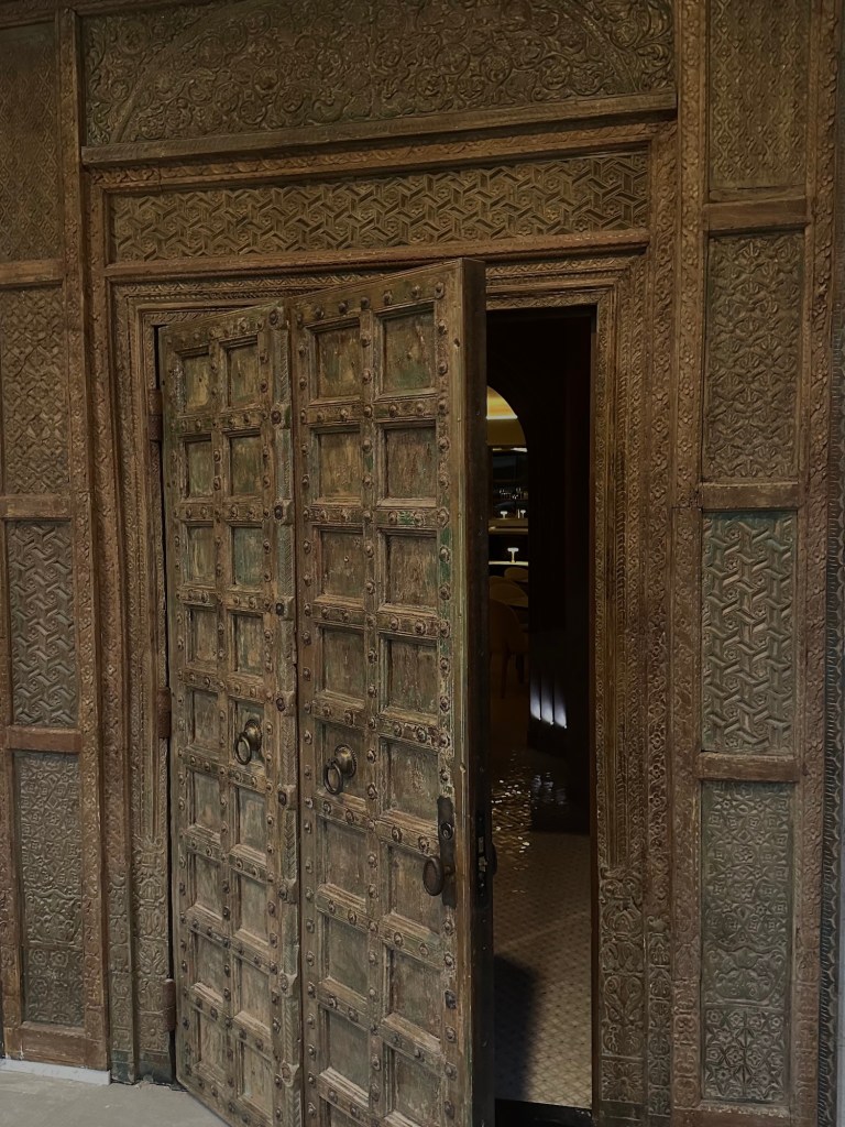 The 18th-century door and carved entry into Babel, a new Mediterranean restaurant in Dallas.