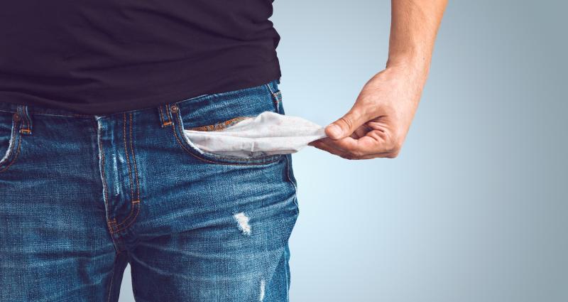 Man turning out empty pocket. Low income is a problem.
