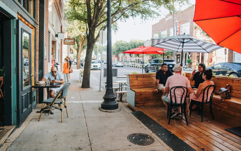 people on a patio in bishop arts