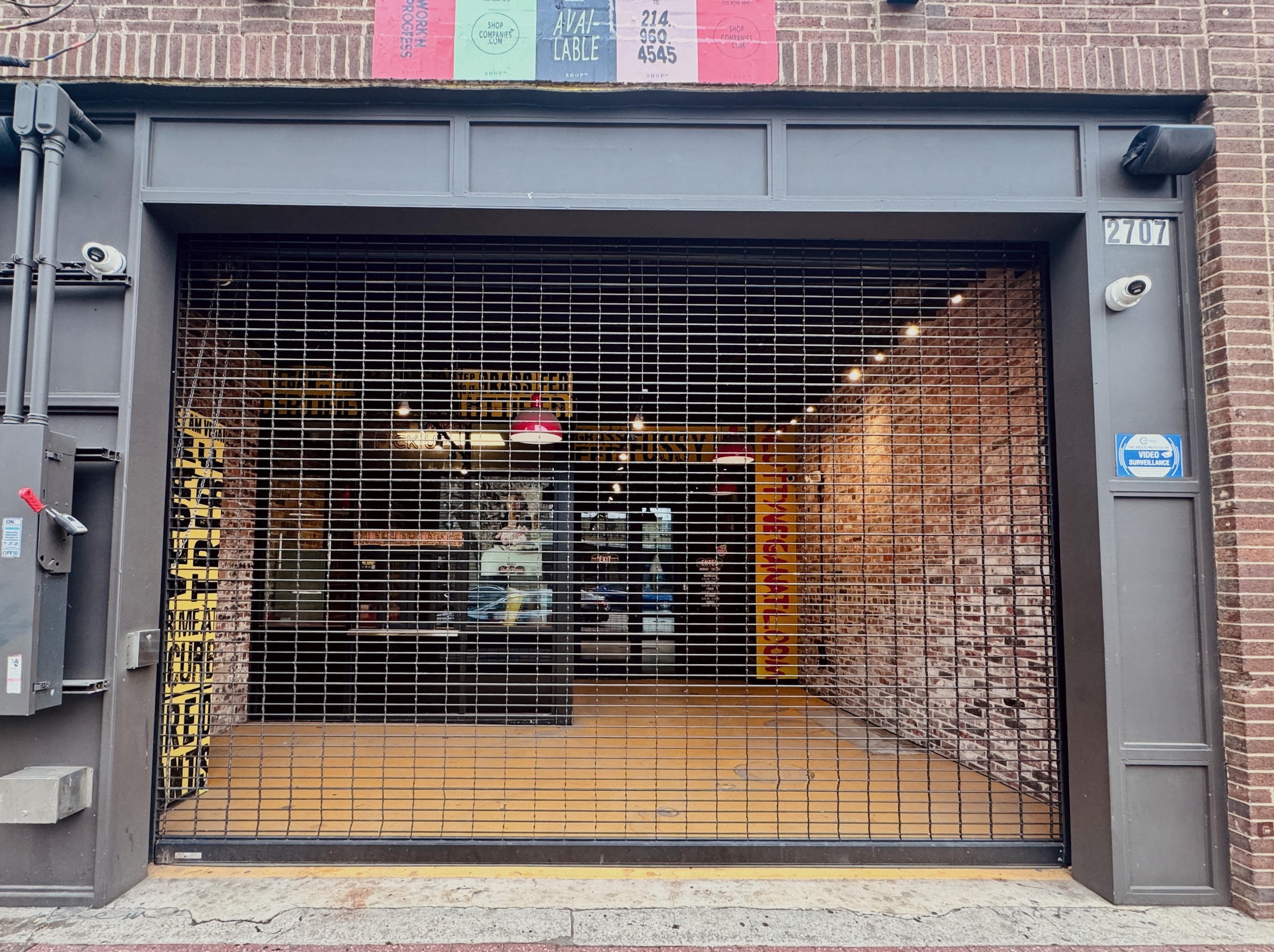 The exterior of Slutty Vega in Deep Ellum with metal shutters pulled down across the facade.