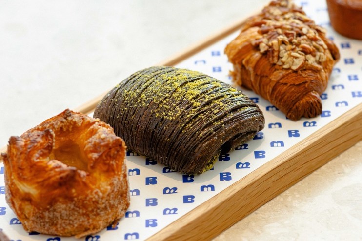 Four elegant pastries on a platter.