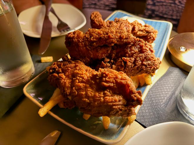 a plate of thick chicken tenders over fries