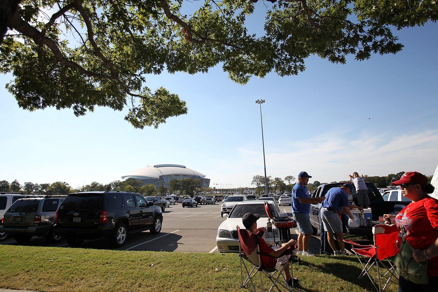 fans tailgating outside of AT&T stadium before a Dallas Cowboys game.