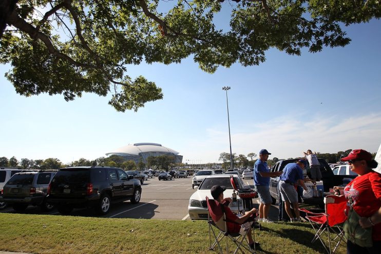 fans tailgating outside of AT&T stadium before a Dallas Cowboys game.