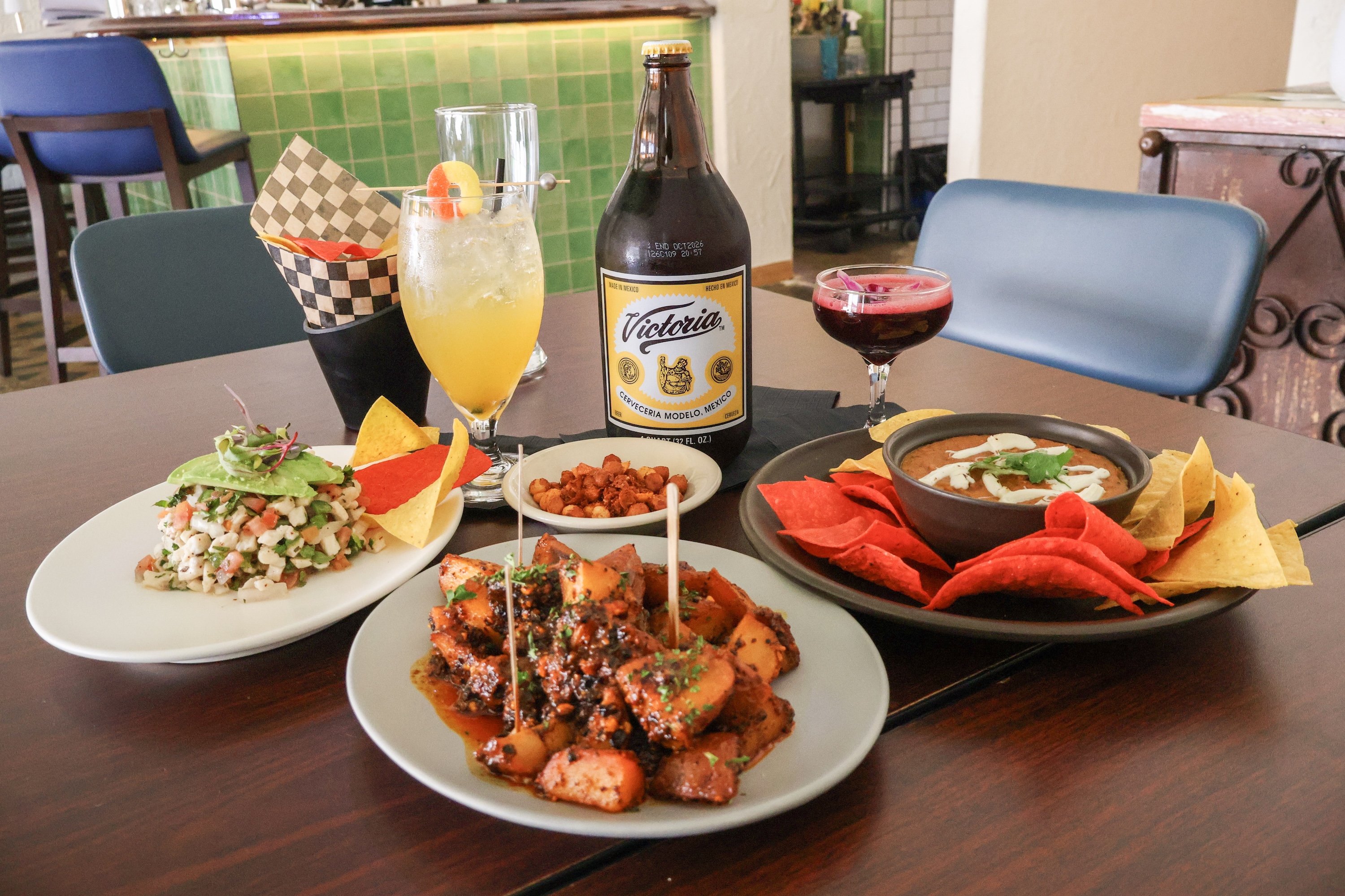 a table filled with botanas and mexican drinks