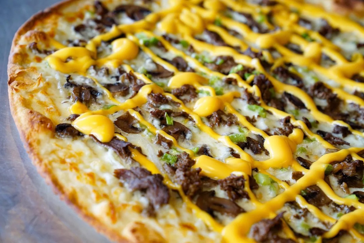 Greenville Avenue Pizza Co. Marches on With a Truck Yard Cheesesteak Pizza