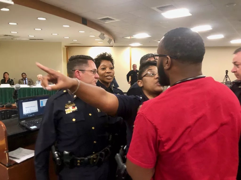 Protesters and Police Scuffle During Inaugural Meeting of Oversight Board