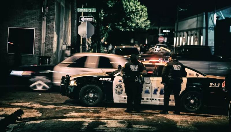 Dallas police officers in Deep Ellum at night