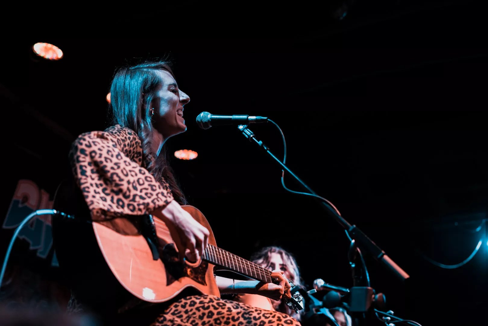 Dallas singer Sarah Johnson plays guitar onstage.