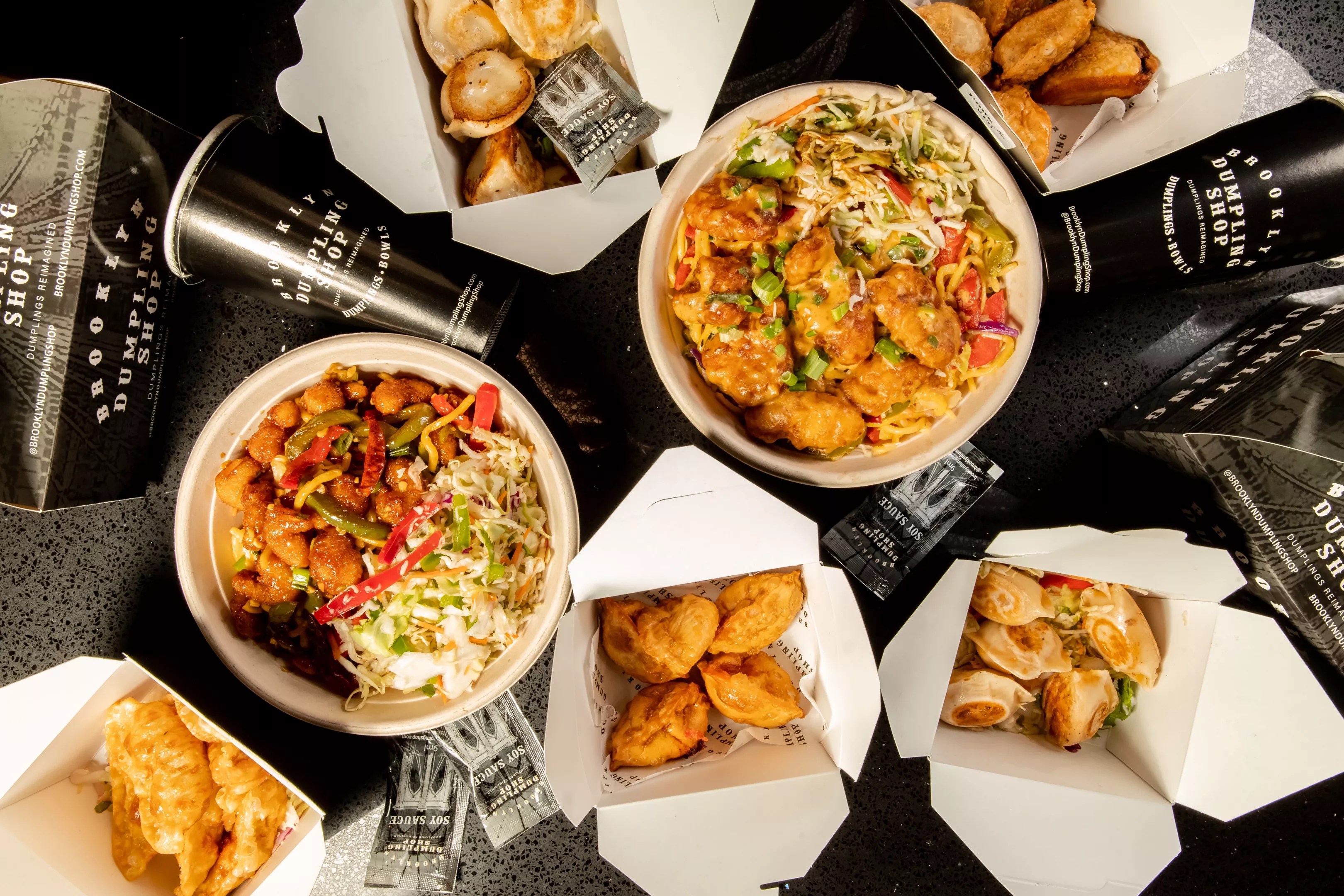 A variety of bowls, dumplings and fried food from the Brooklyn Dumpling Shop.