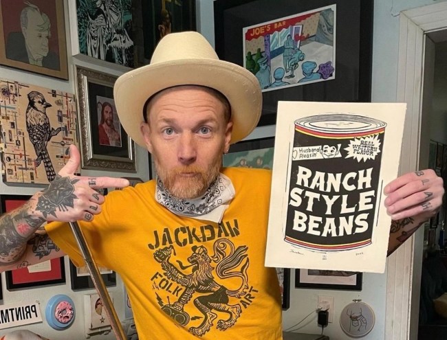 Fort Worth artist Jack Daw poses with a drawing of Ranch Style beans. He draws Texas scenes like no other: with humor and wit.