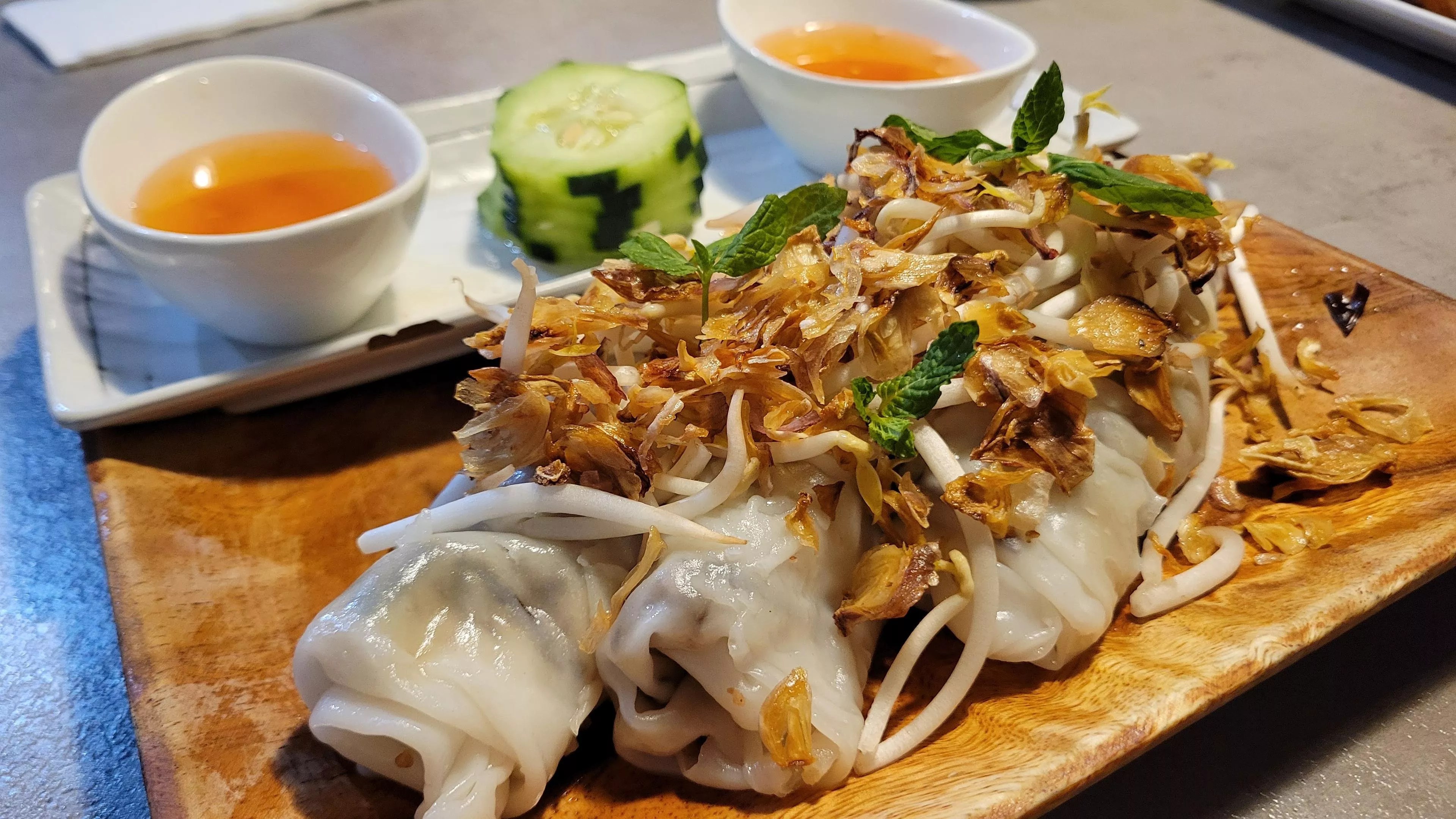 Steamed rice rolls topped with fried shallots at Four Sisters in Mansfield