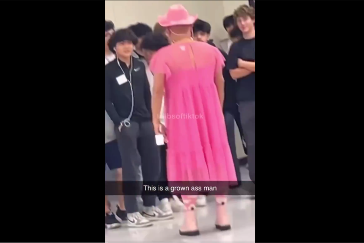 Screenshot of a male Hebron teacher wearing a dress.