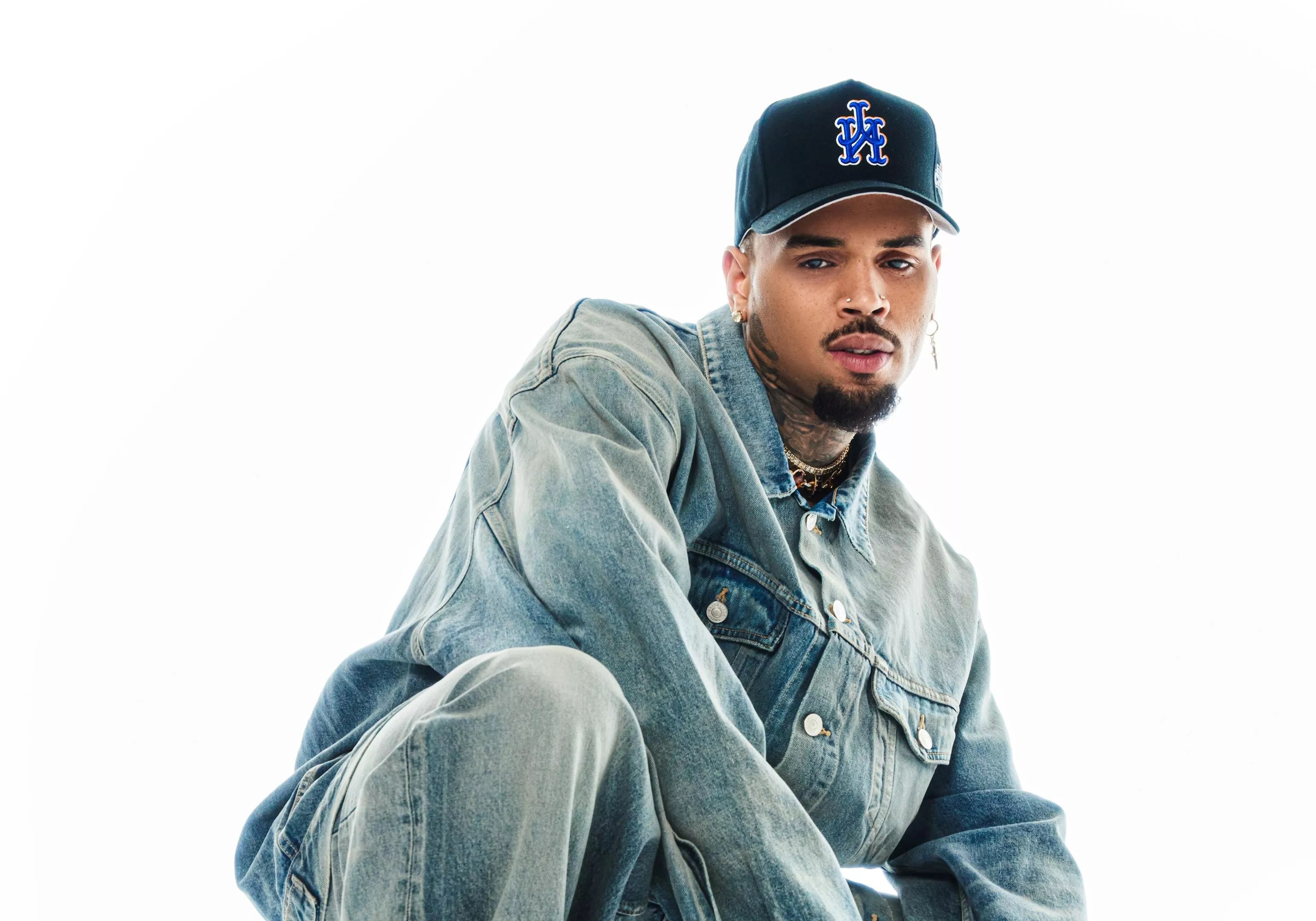 Singer Chris Brown wears all-denim. The artist is playing
