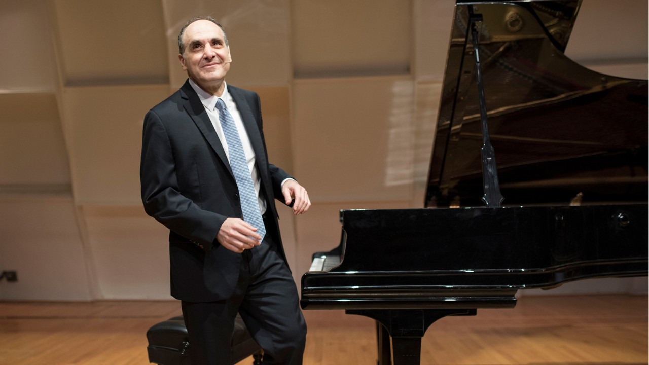 Dallas Symphony Orchestra's Dr. Richard Rogan near a piano.