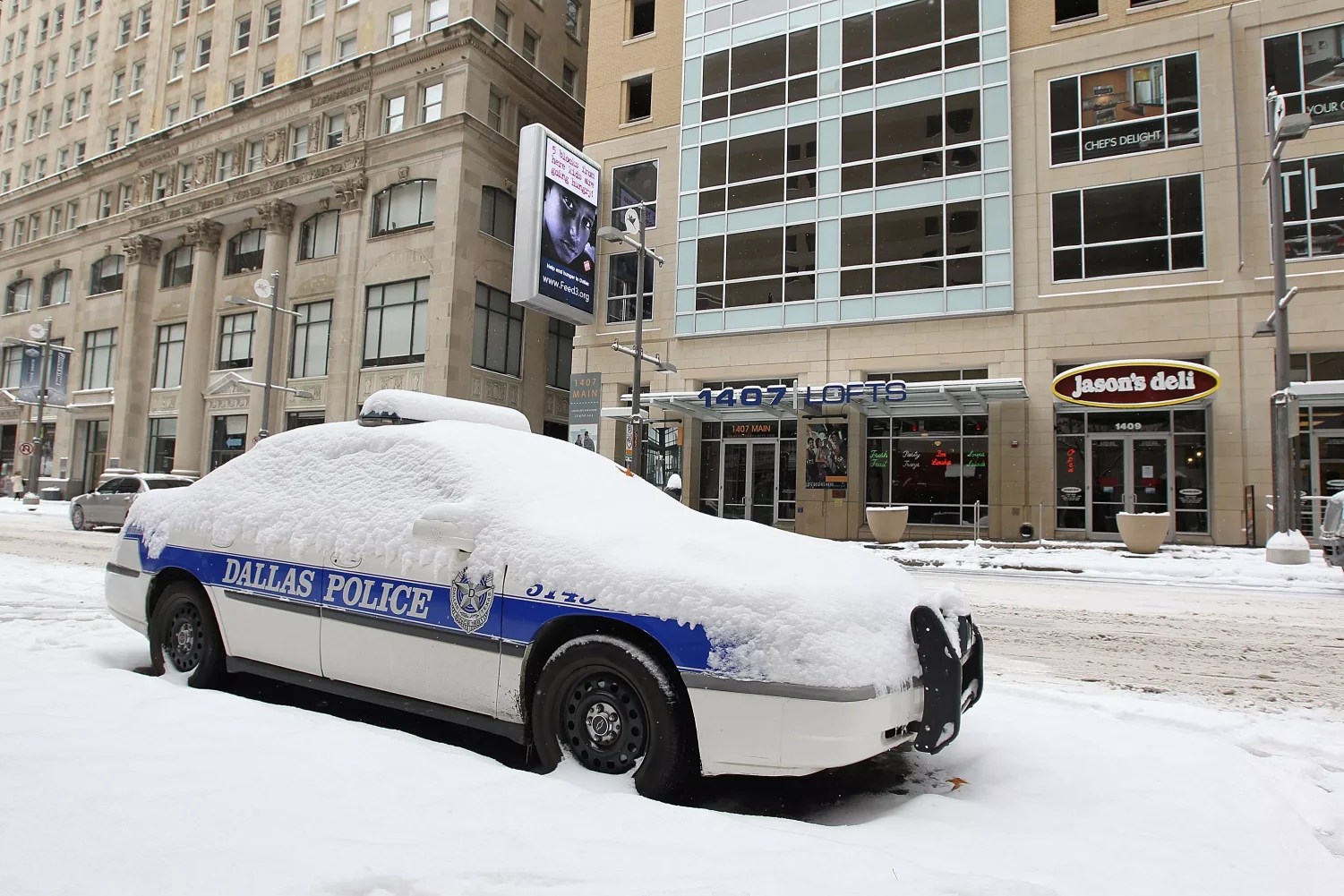 dallas police car covered in snow