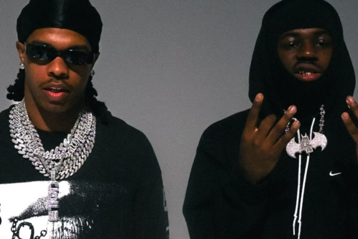 Two men with chains staring at the camera