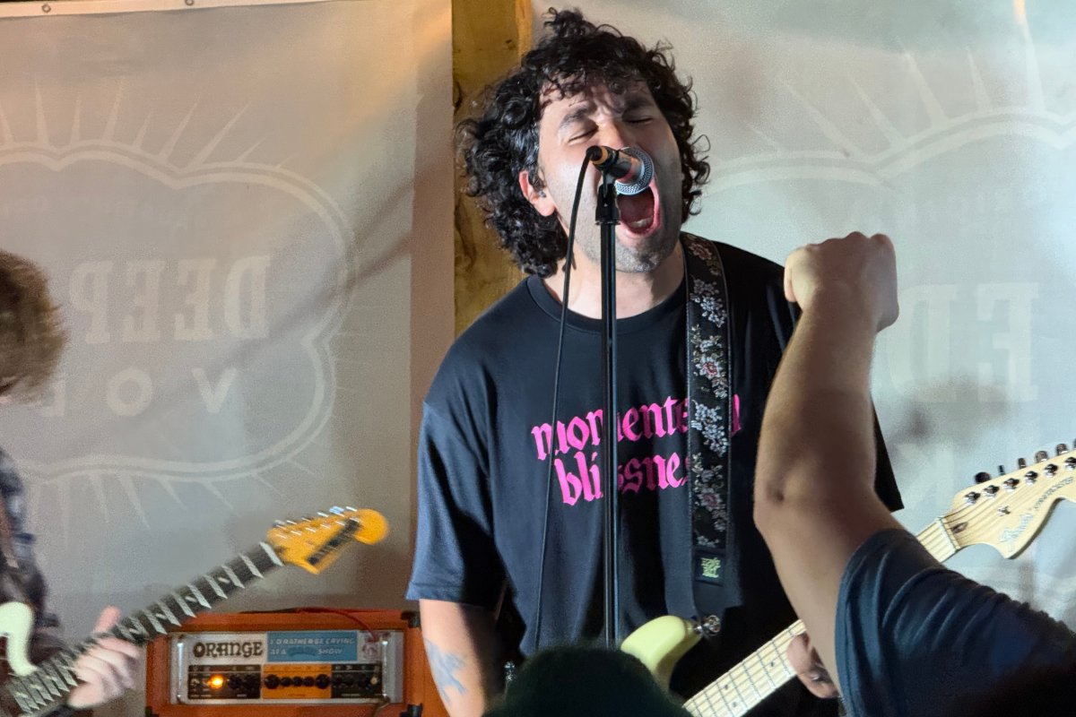 Man screaming into a microphone on stage