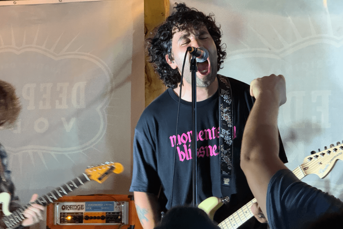 Man screaming into a microphone on stage