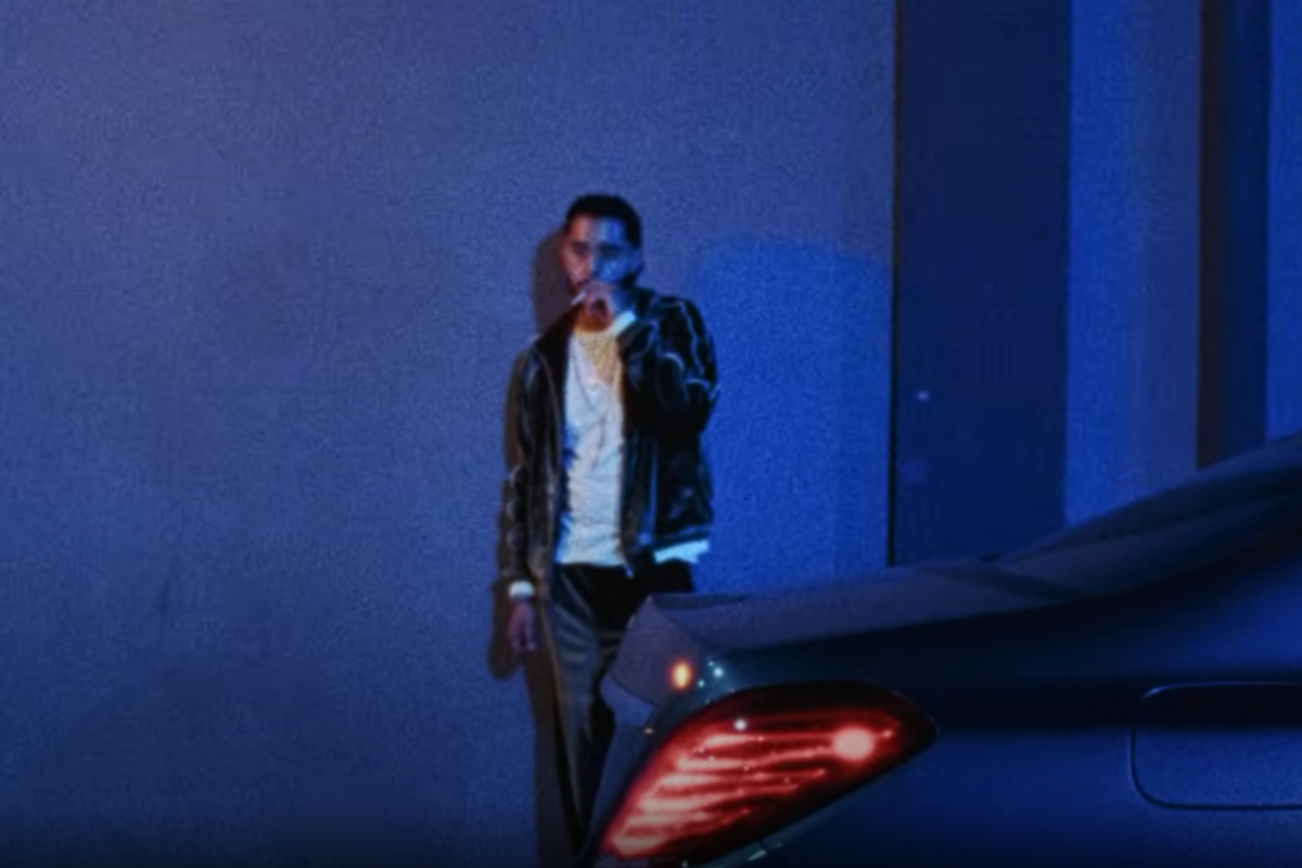 Man smoking in front of car