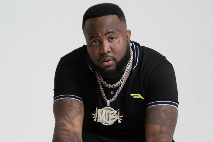 A man sitting down with chains