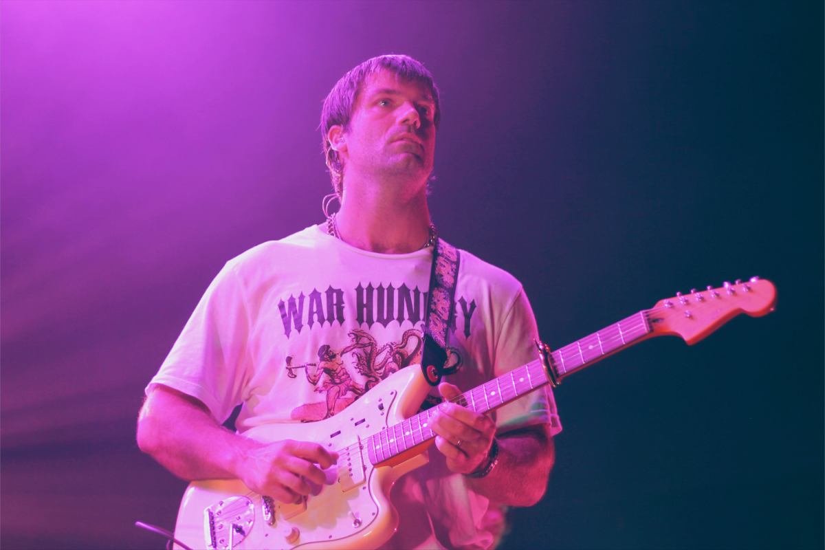 Man performing with guitar on stage