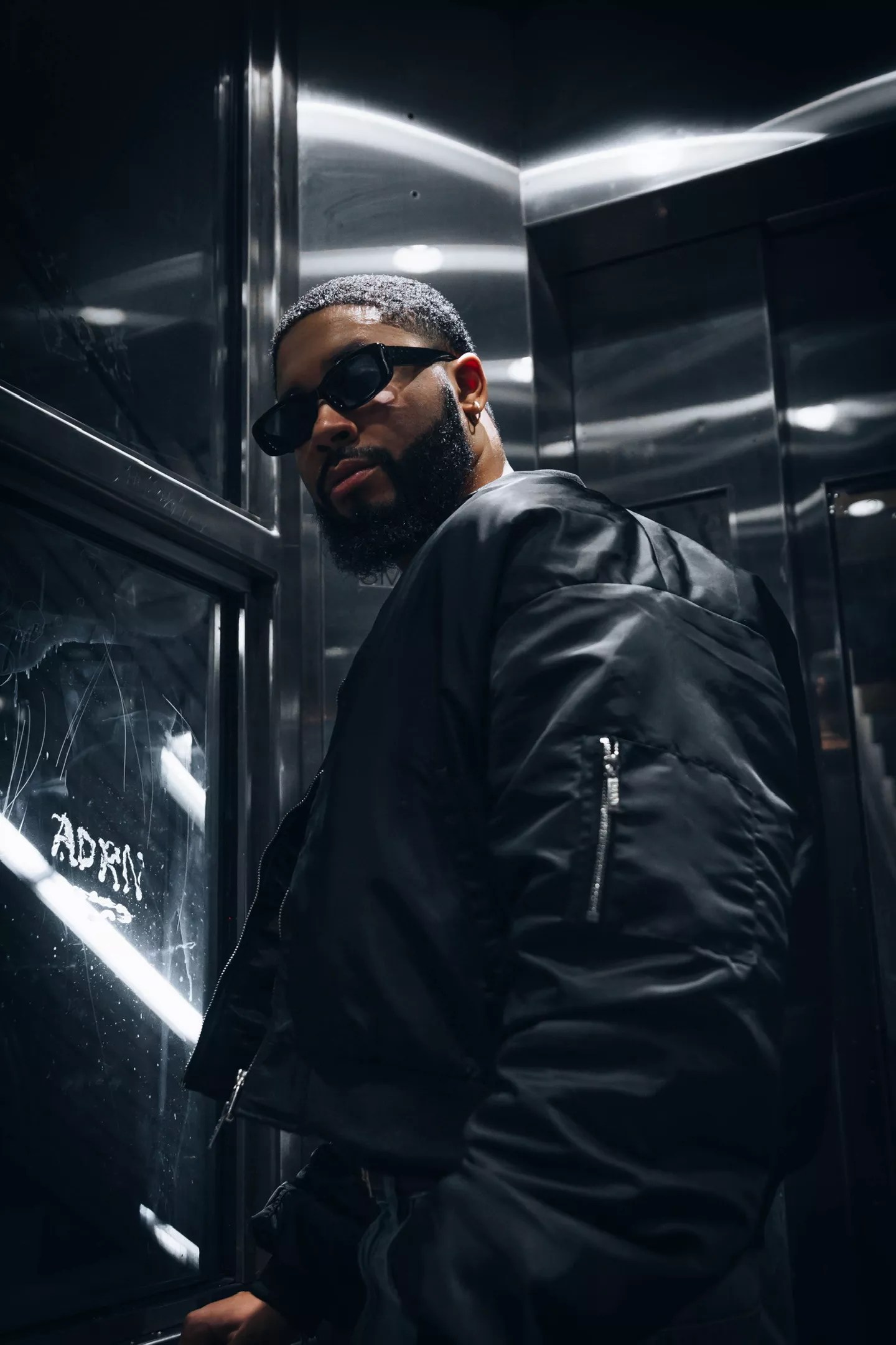 Man posing in front of bridge