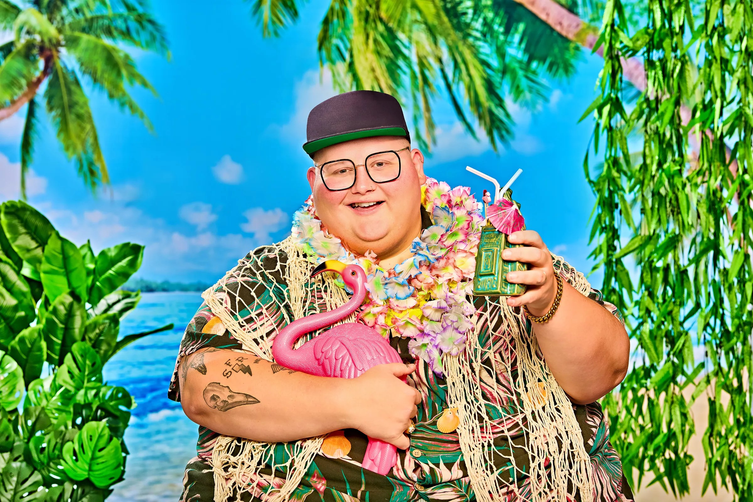 Man holding a drink and flamingo