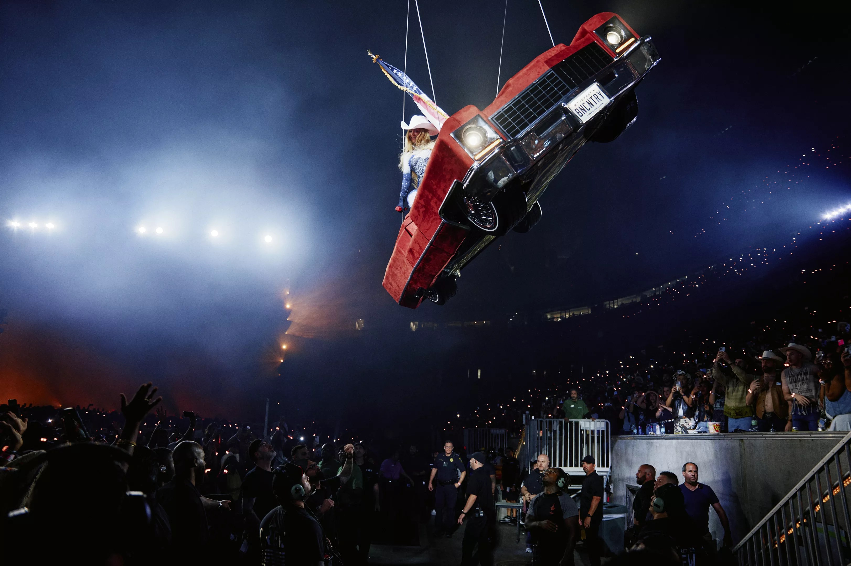 Woman in a car over fans