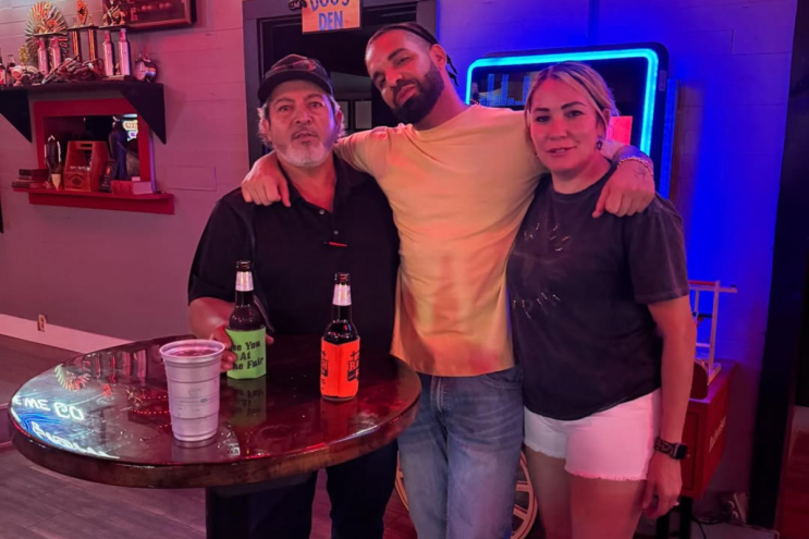 Man posing with fans
