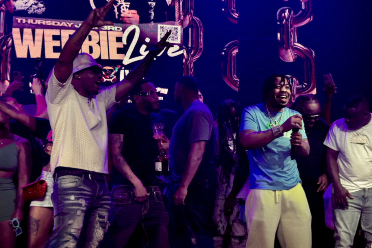 A picture of a rapper on stage